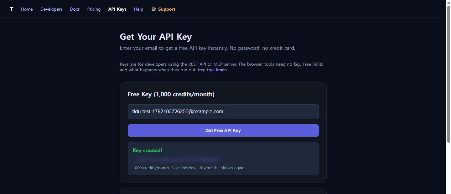 The API key page showing a freshly created free key with 1,000 credits per month, key value blurred